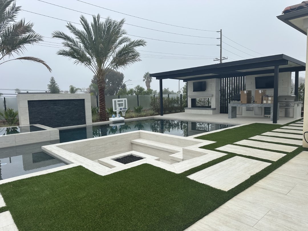 Paver pool deck and walkway with synthetic turf